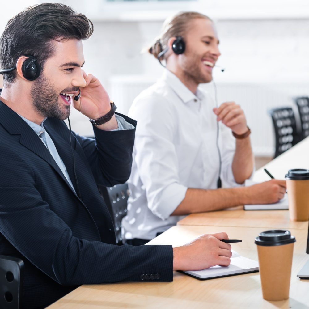 side-view-of-male-call-center-operators-in-headsets-at-workplace-in-office-1